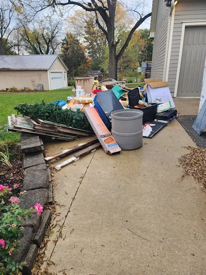 Dumpster being loaded with debris for 10 Yard Dumpster Rental in Spring Grove
